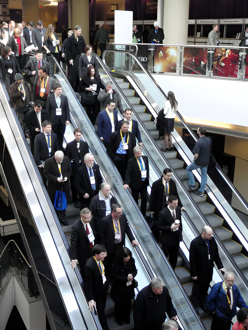 Conference delegates descending an escalator