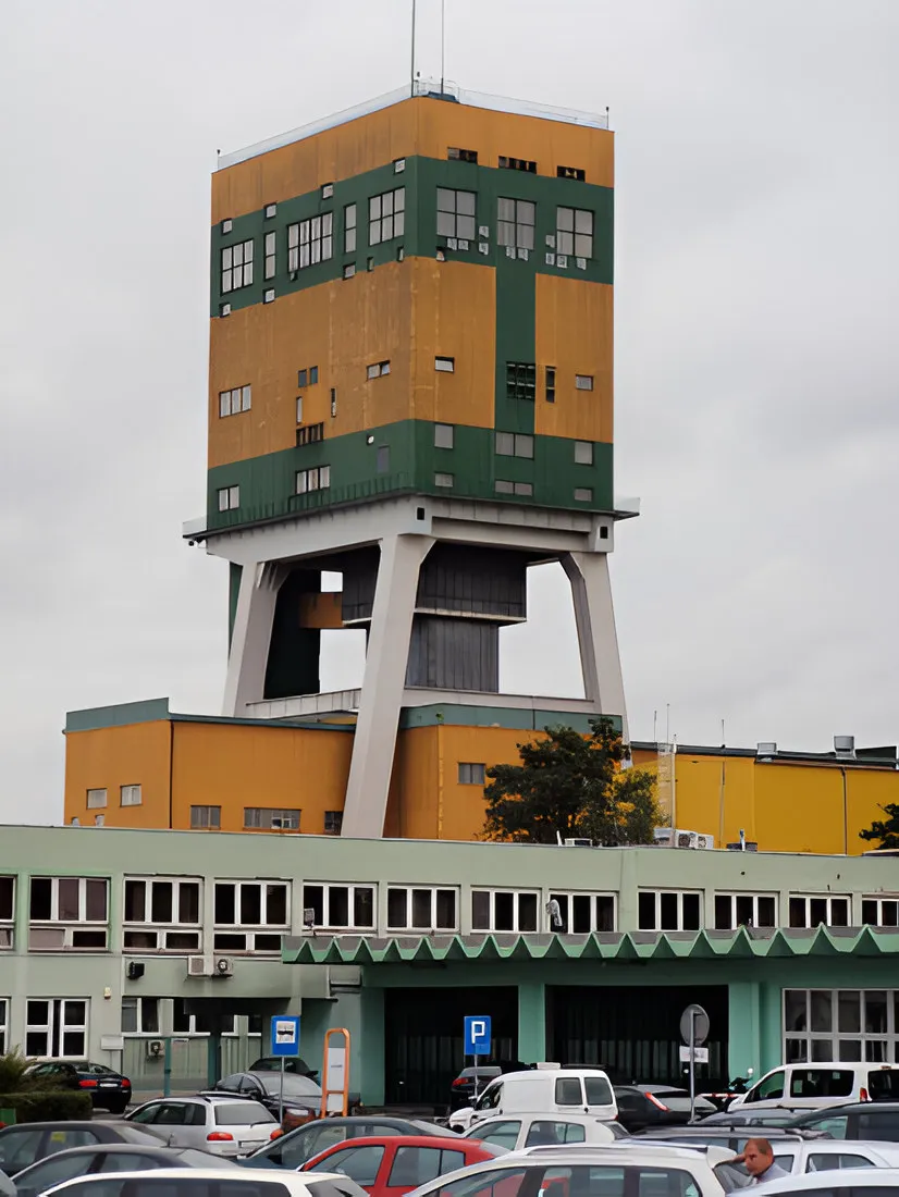 Mine shaft tower and surface buildings with a car park in front