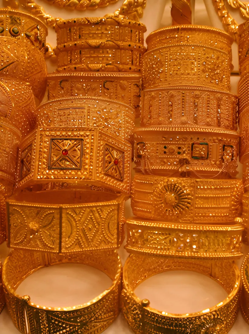Stacked ornate gold bangles