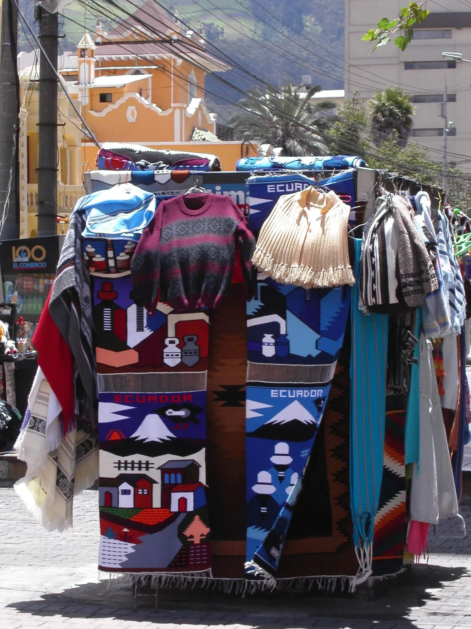 Street stall hung with colourful woven textiles