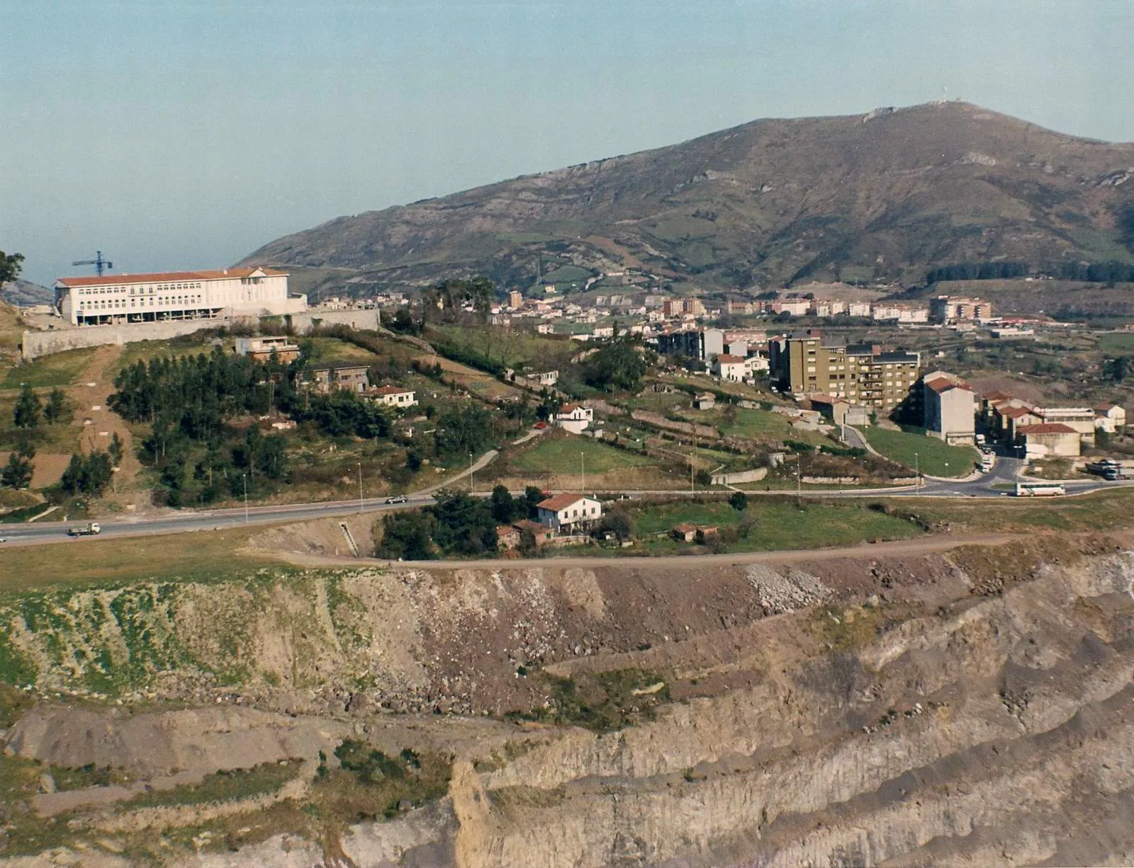 Open-pit mine below the town of Gallarta with a mountain behind, Basque Country