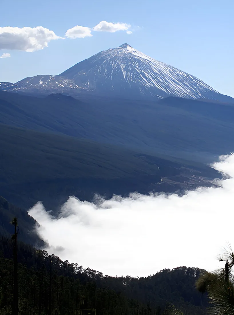 Snow-dusted Teide volcano rising above a sea of clouds