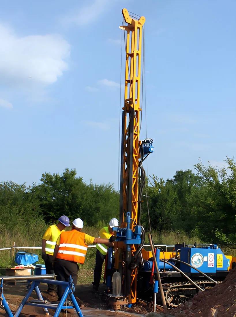 Drilling rig with workers in hard hats and high-visibility vests